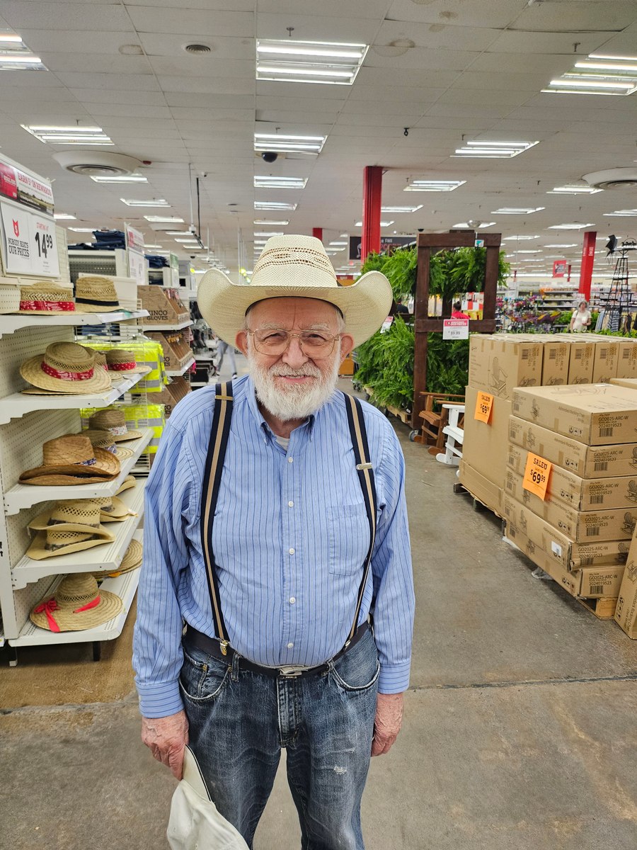 Grandfather smiling in a cowboy hat in a shop