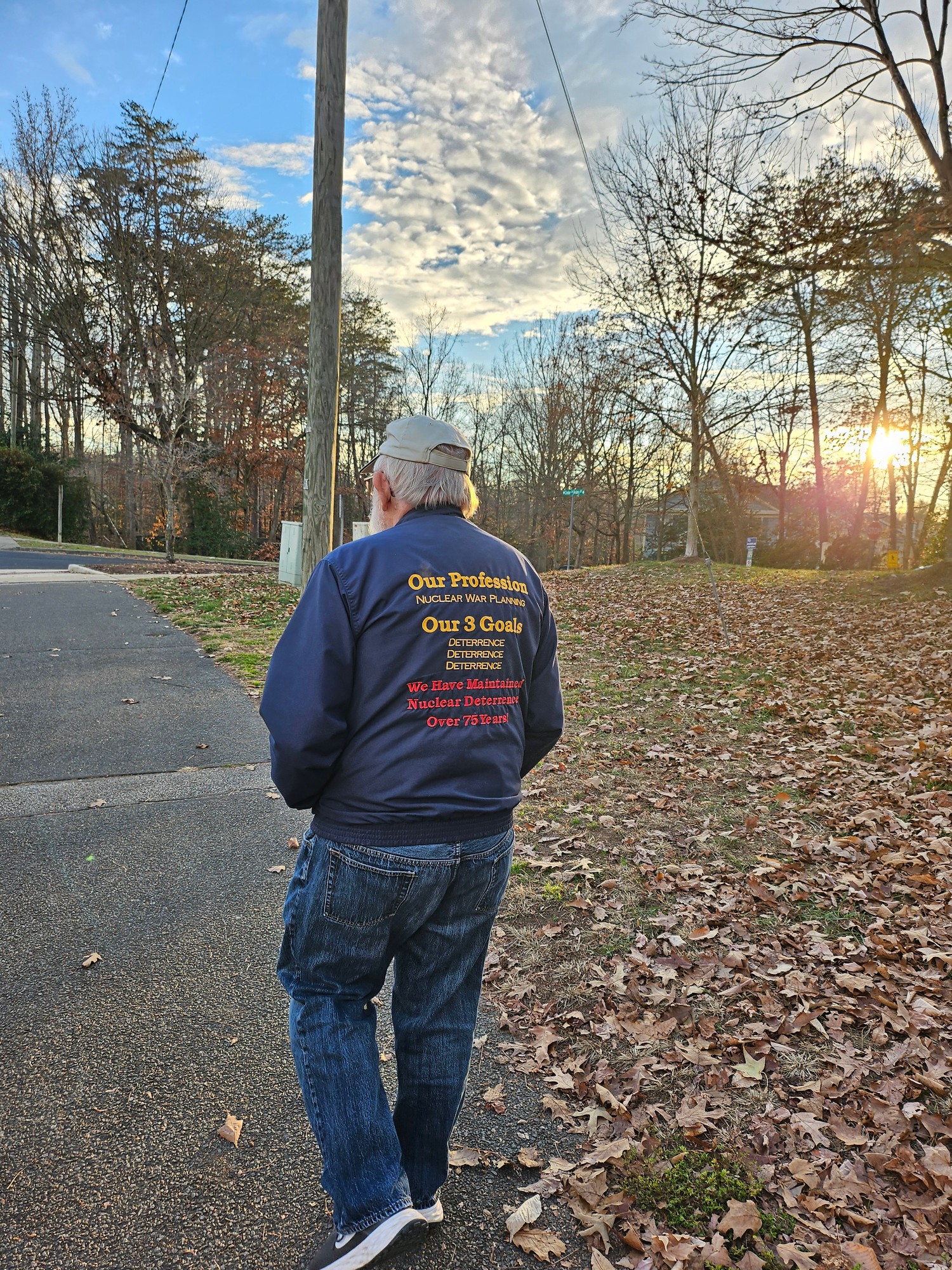 Grandfather photographed from behind, walking in his blue jacket