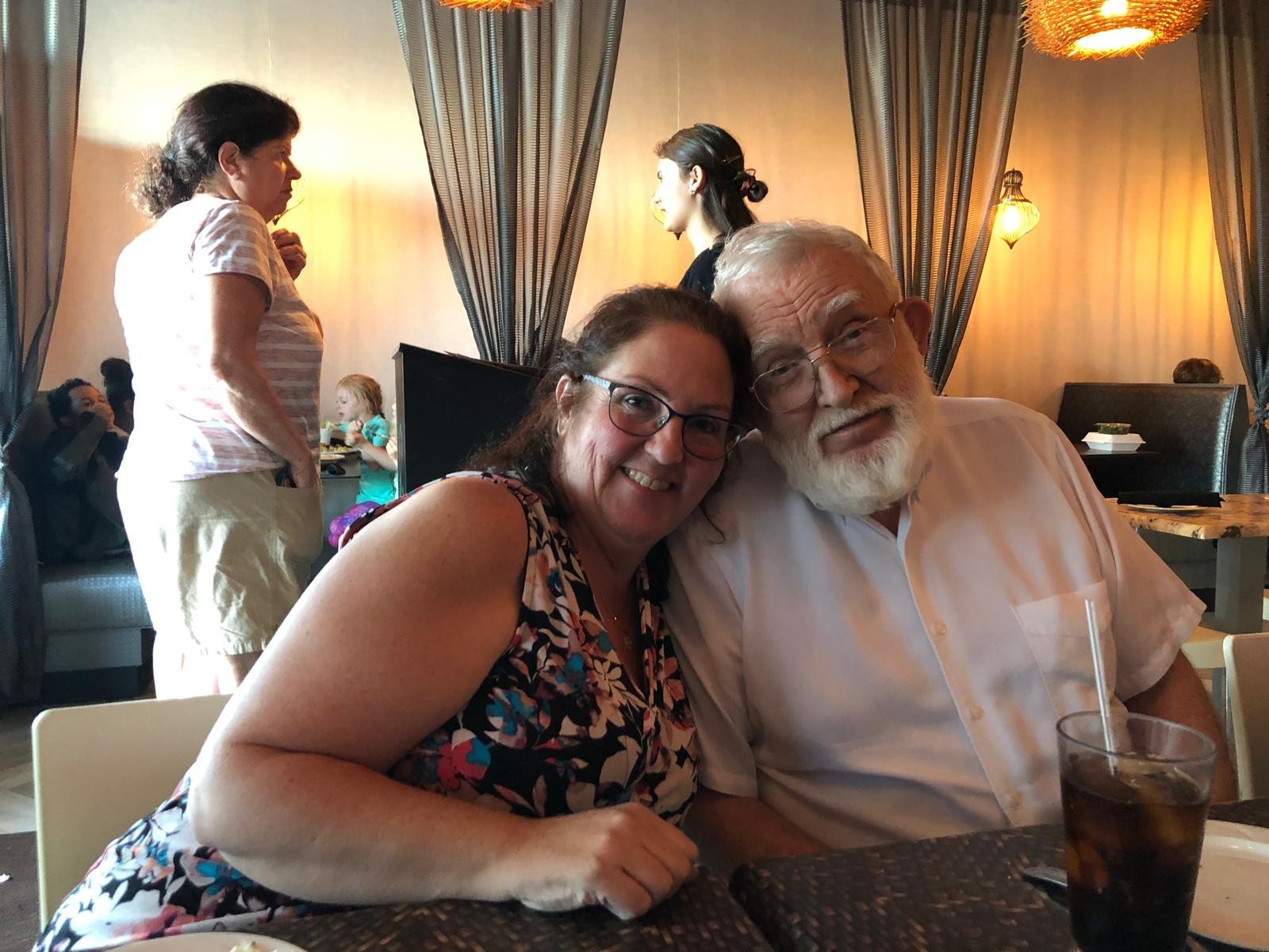 Two people smiling together at a restaurant table